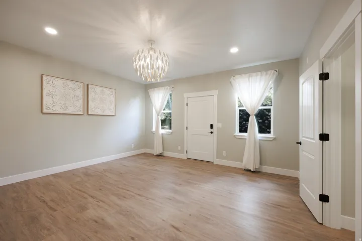 Spacious main bedroom featuring an ensuite, 2 walk-in closets and door to deck with hot tub.