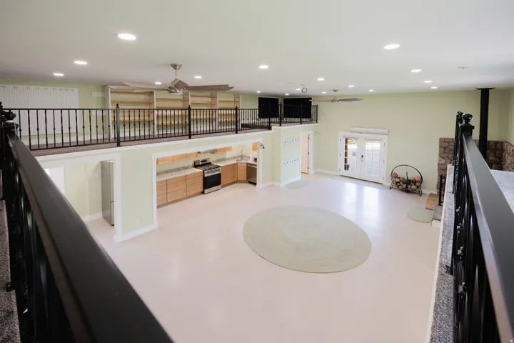 Expansive open-concept living space with light-toned flooring and a large loft area.