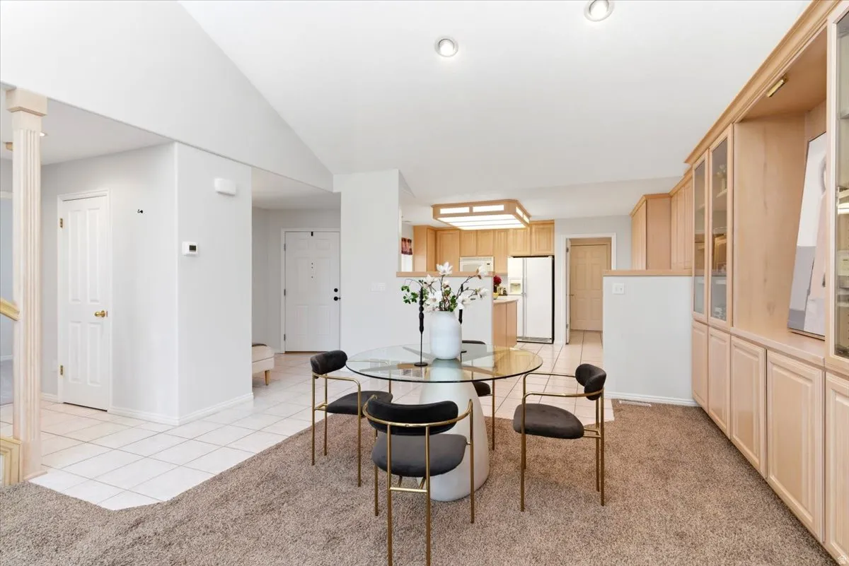Open-concept living space with a dining area featuring a glass-top table