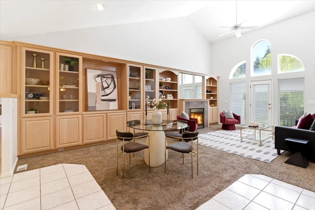 Spacious living area featuring a vaulted ceiling and custom built-in cabinetry