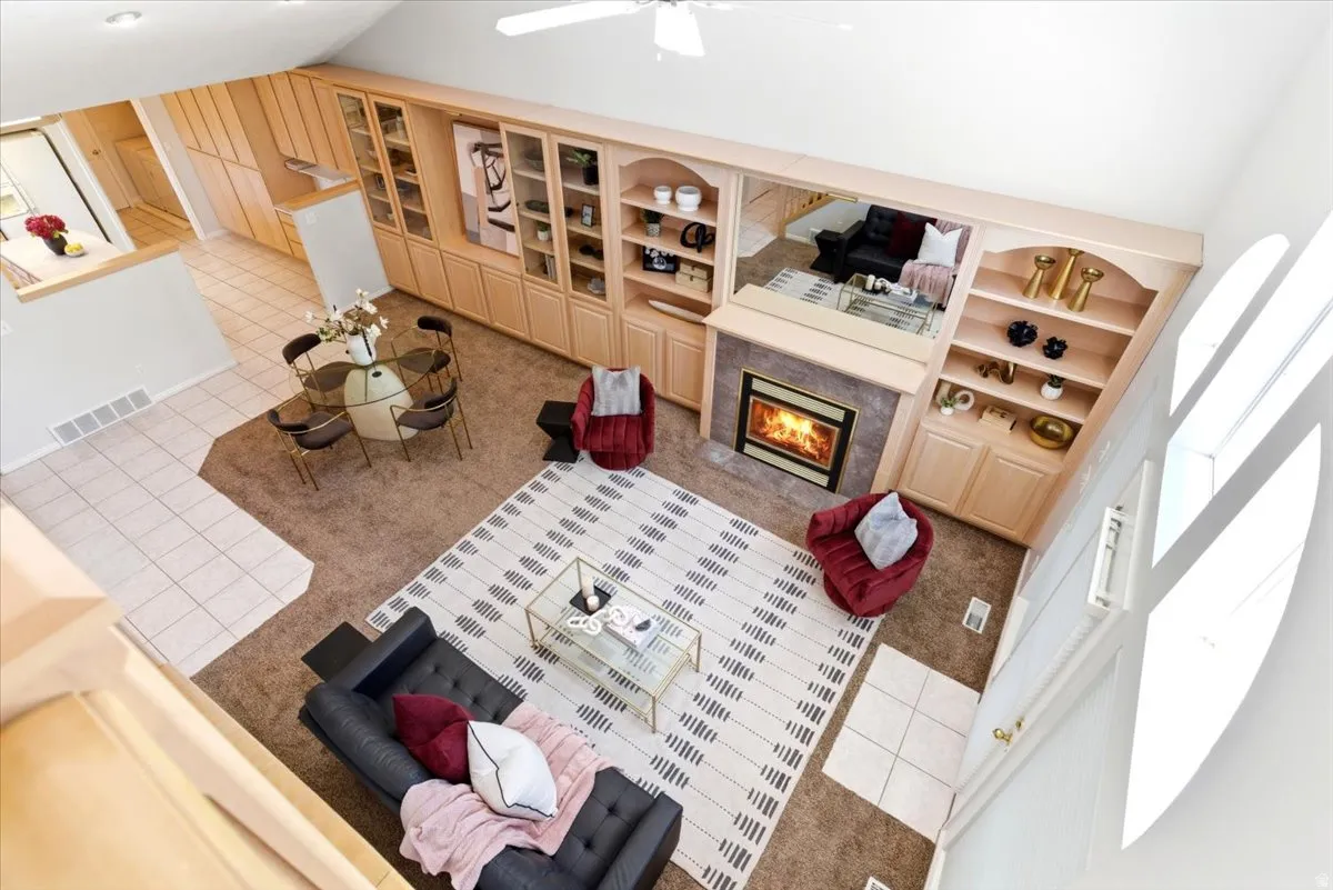 Open-concept living area with a vaulted ceiling. View from loft area.