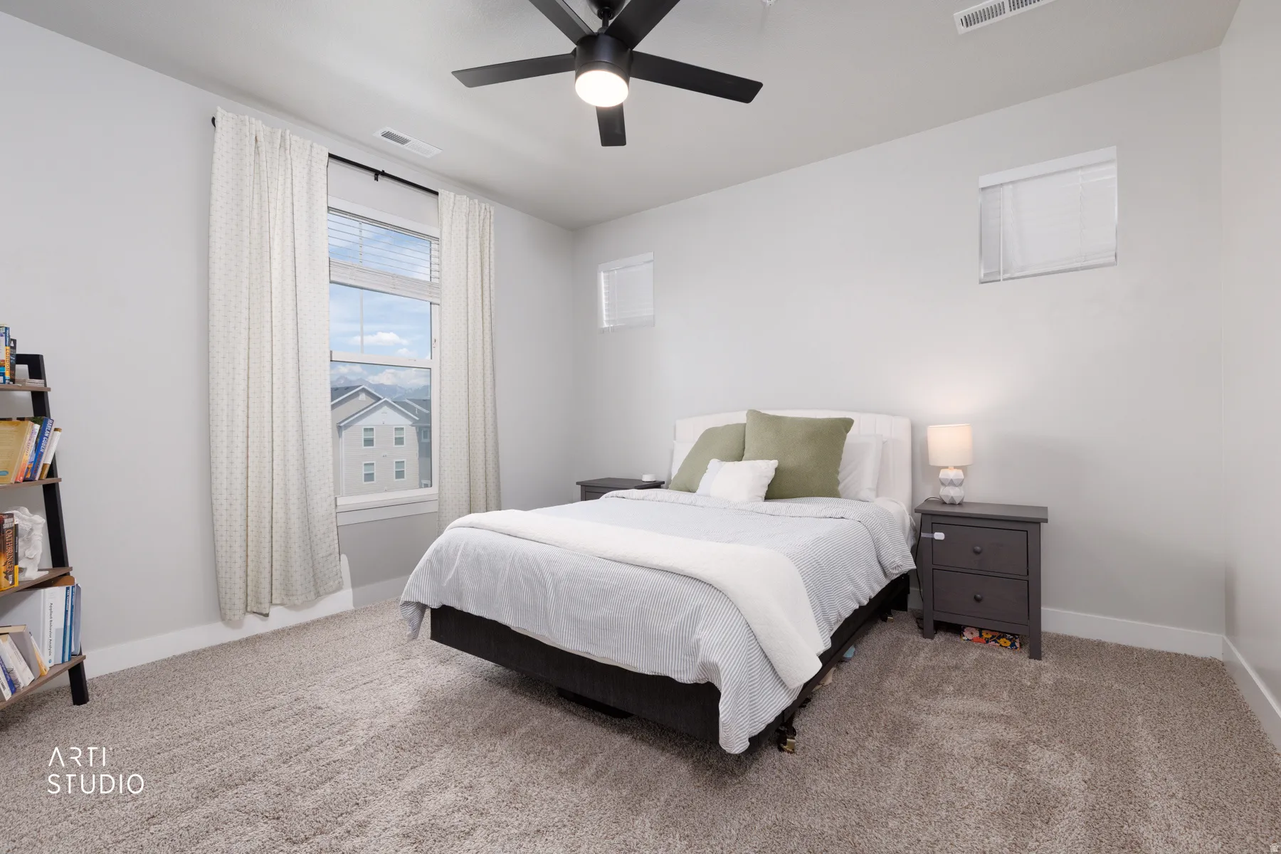 Carpeted bedroom featuring a ceiling fan with integrated lighting, a large window with blinds, and white baseboards