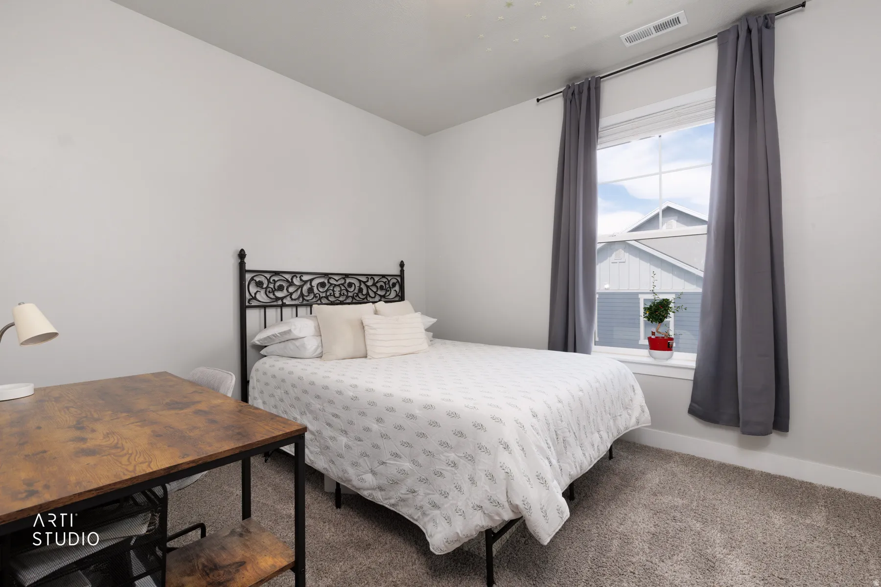 Spacious room featuring light gray walls and plush gray carpeting