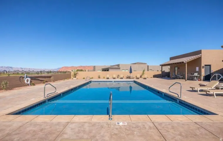 Rectangular swimming pool featuring a tiled perimeter and integrated entry steps