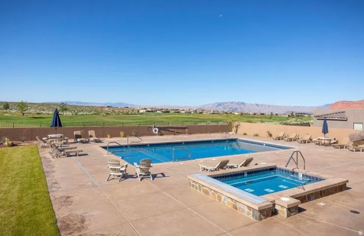 Outdoor swimming pool with integrated spa and extensive surrounding patio