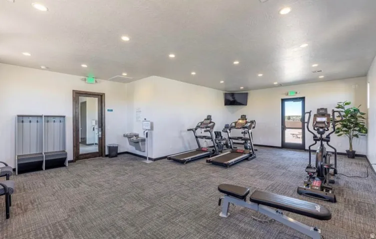Fitness room featuring recessed lighting, patterned carpet flooring, and a glass-paneled exterior door
