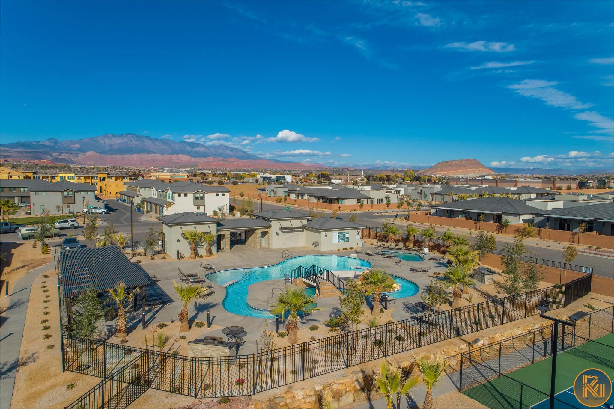 Community amenities featuring a resort-style pool, multiple lounge areas, a shaded pergola, and a tennis court