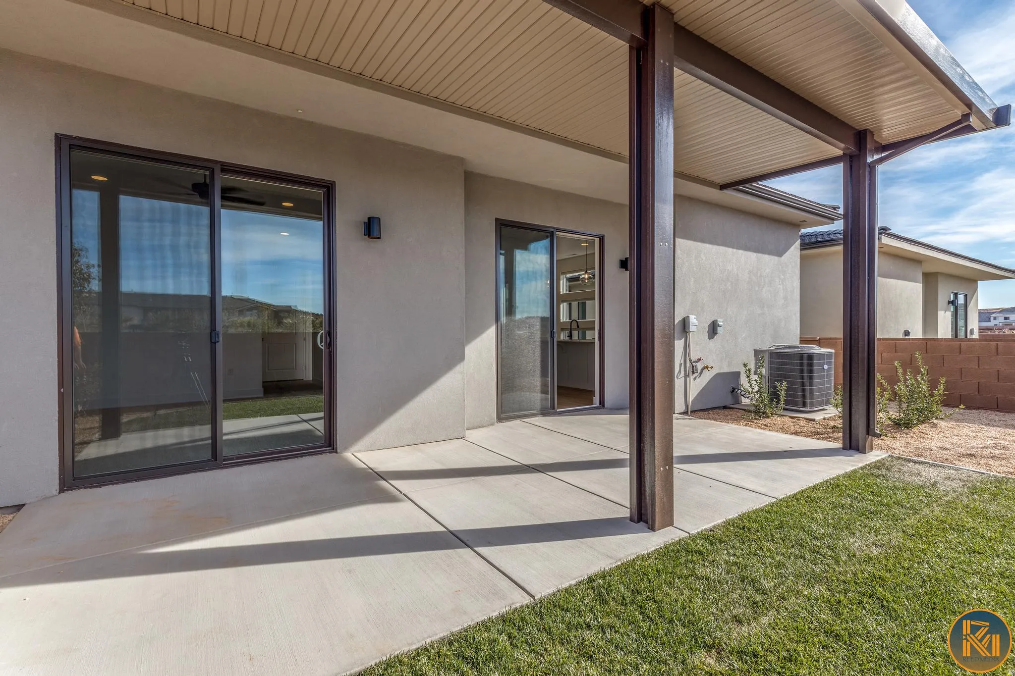 Covered patio featuring concrete flooring and dual sliding glass doors
