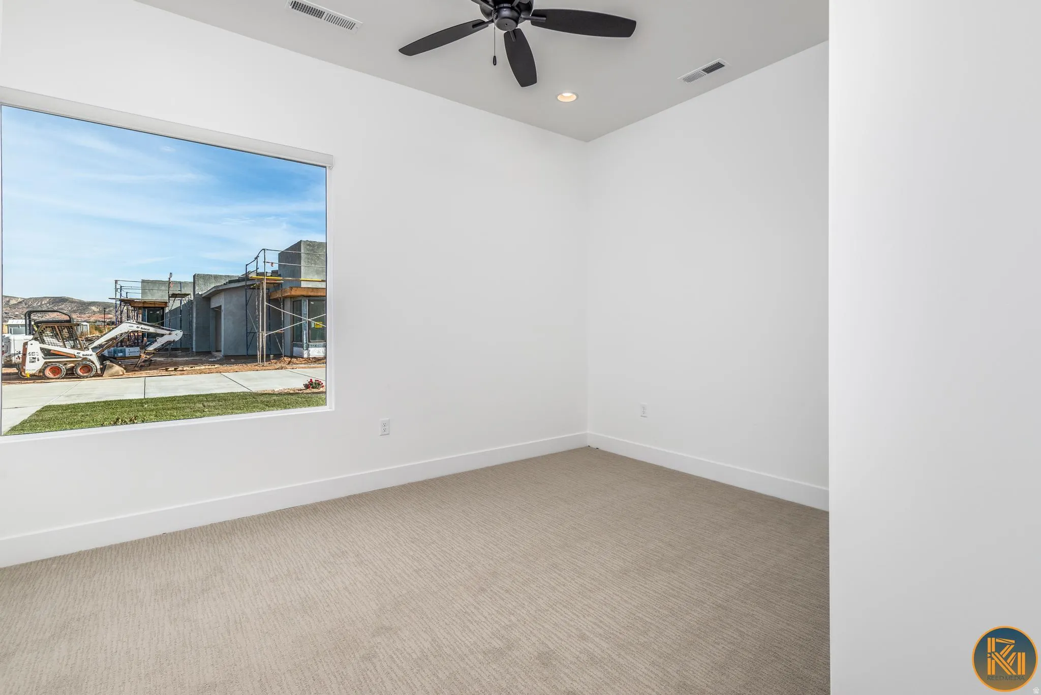 Room featuring light-toned carpet flooring, white walls, and white baseboards