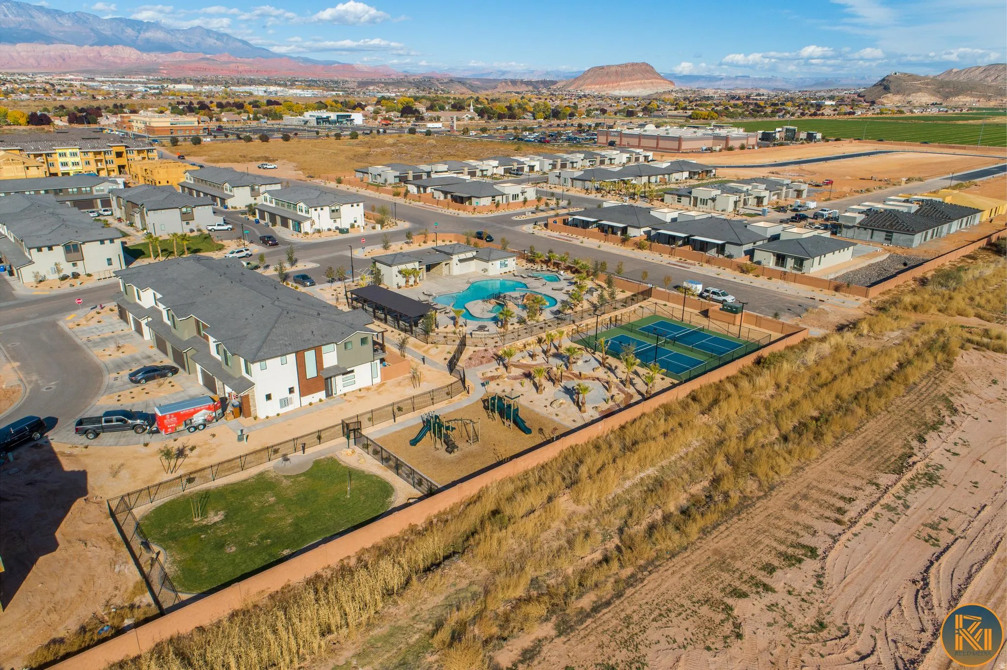 Community amenities featuring a swimming pool, tennis courts, and playground areas with mountain scenery
