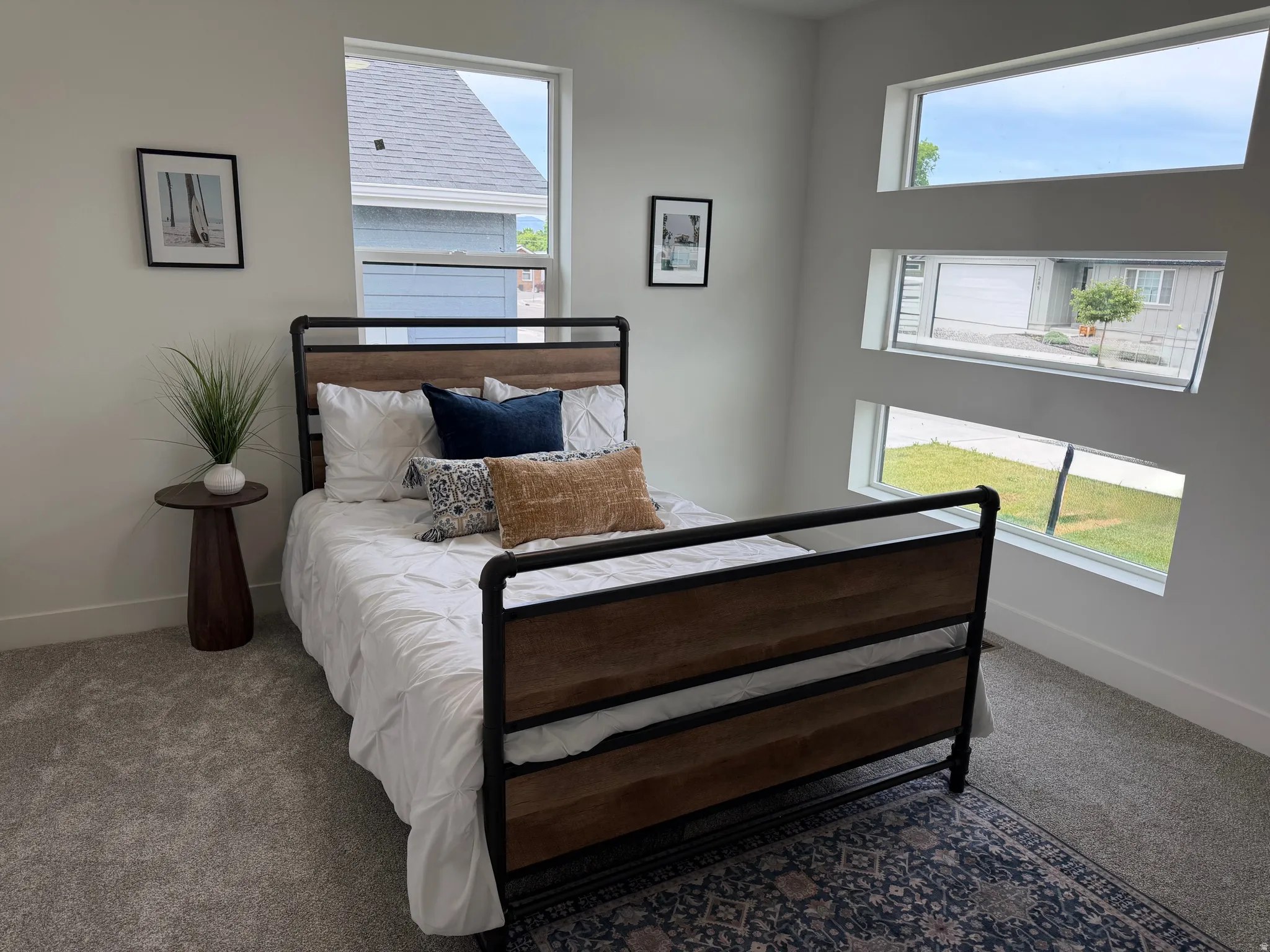 Bedroom featuring light gray carpeting and white walls