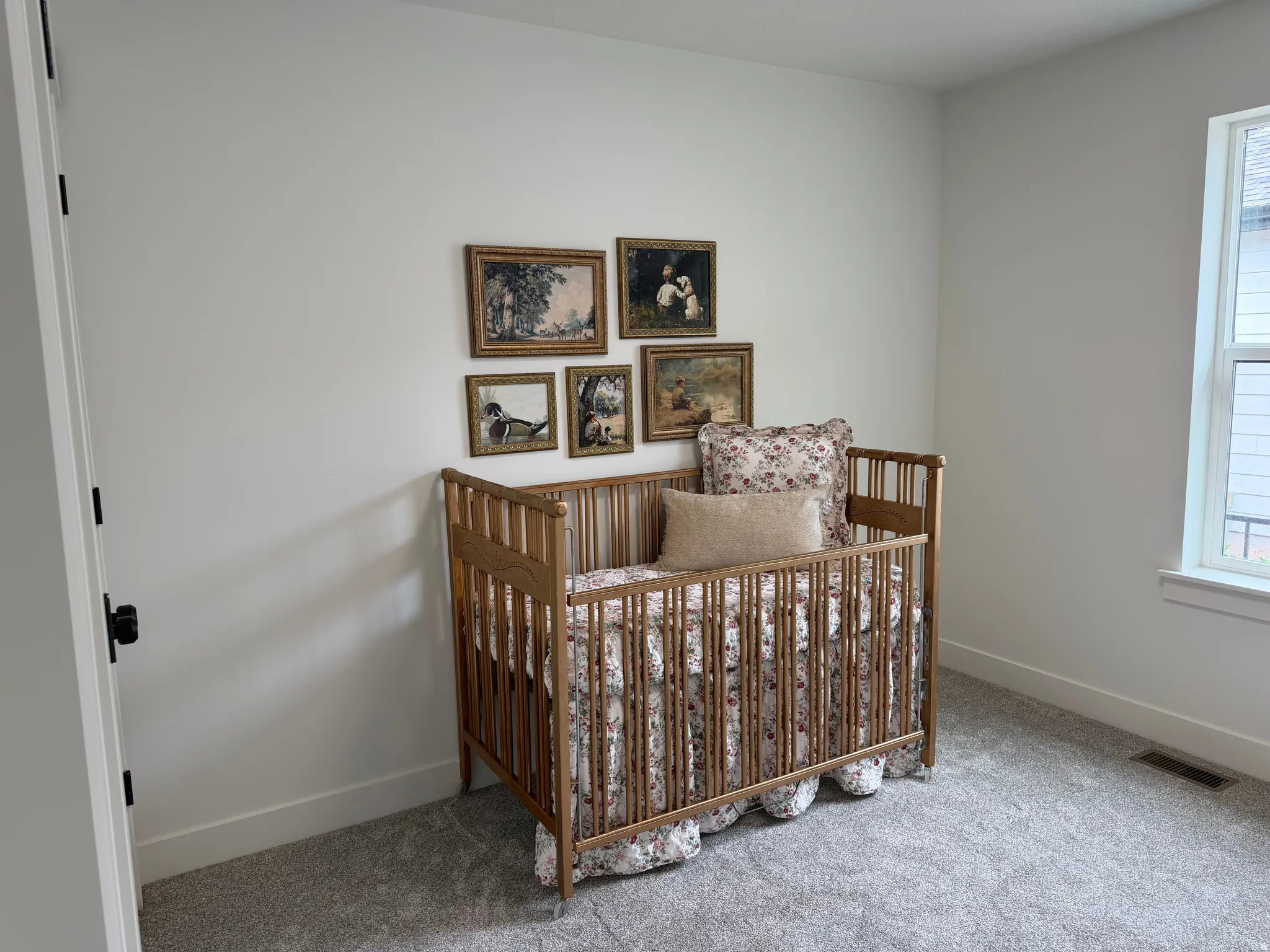 Bedroom featuring light gray carpeting, white walls, and a white trim package