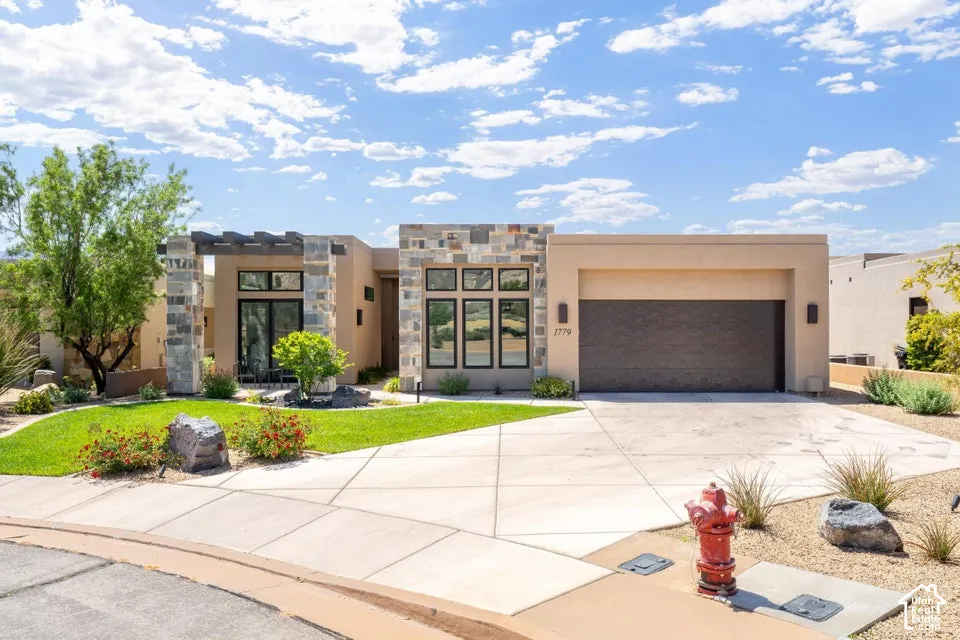 Modern desert contemporary home featuring stucco and stone veneer facade