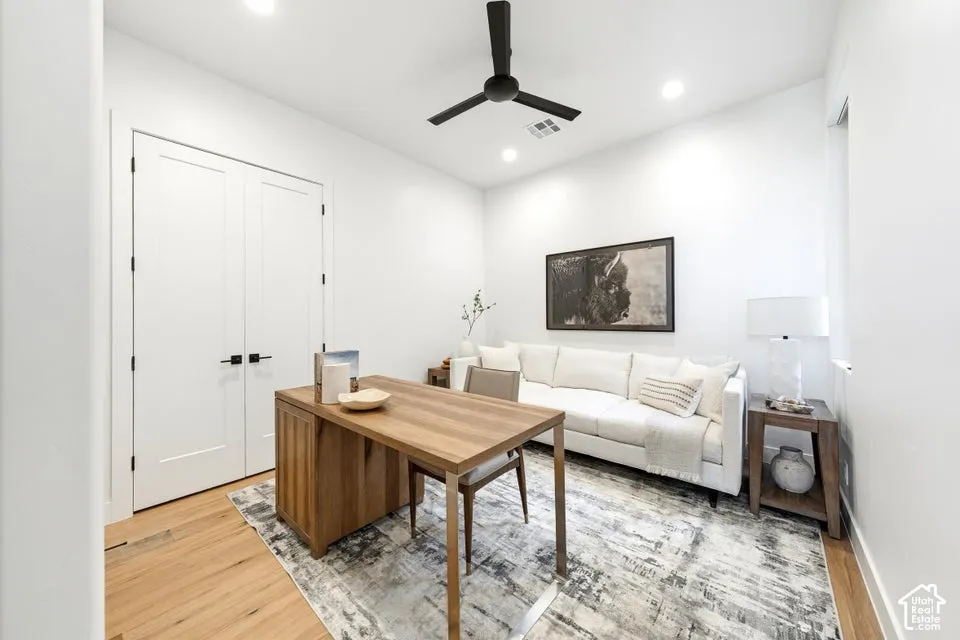 Bright room featuring recessed lighting, a ceiling fan, and light wood-finish flooring