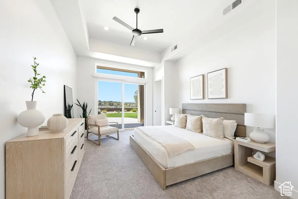 Bright bedroom featuring a vaulted ceiling and a ceiling fan