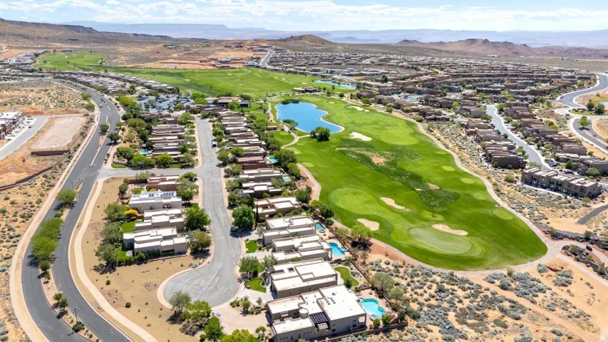 Aerial perspective showcasing residential properties bordering a manicured golf course