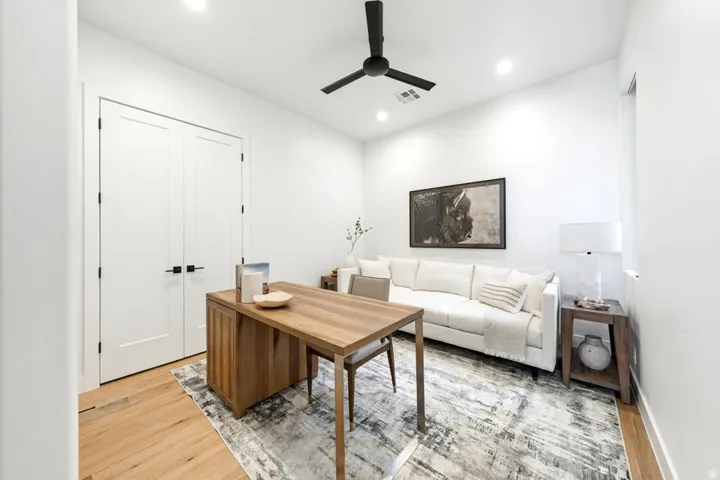 Bright room featuring recessed lighting, a ceiling fan, and light wood-finish flooring