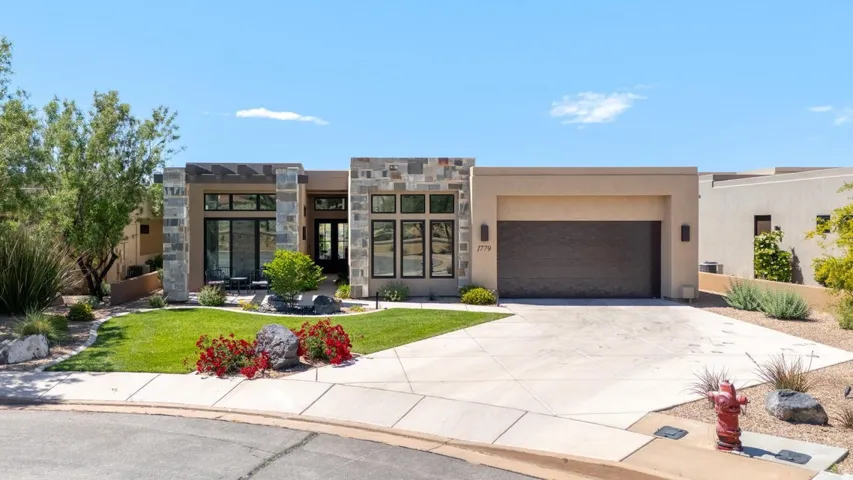 Contemporary stucco exterior with stone accents and a flat roofline
