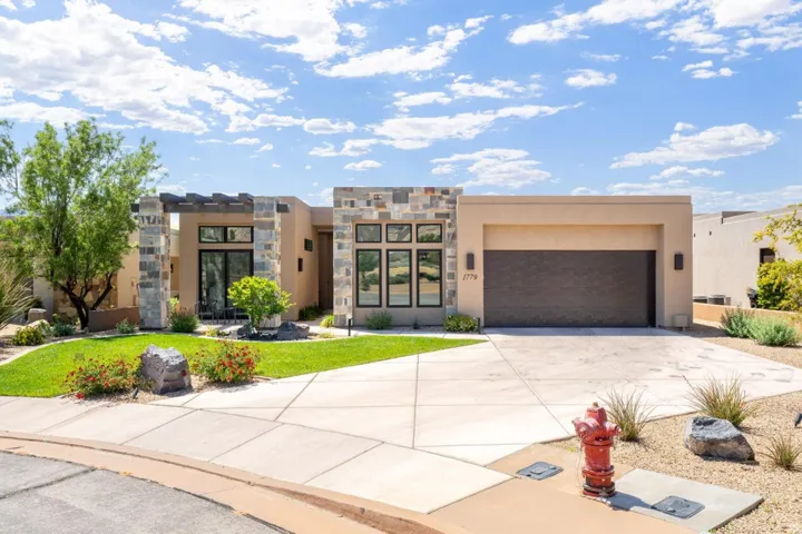 Modern desert contemporary home featuring stucco and stone veneer facade
