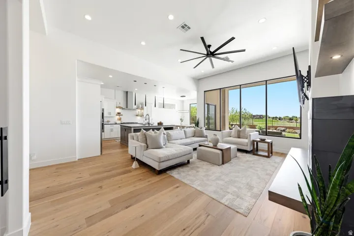 Open-concept living space featuring wood-finish flooring, recessed lighting, and a contemporary ceiling fan