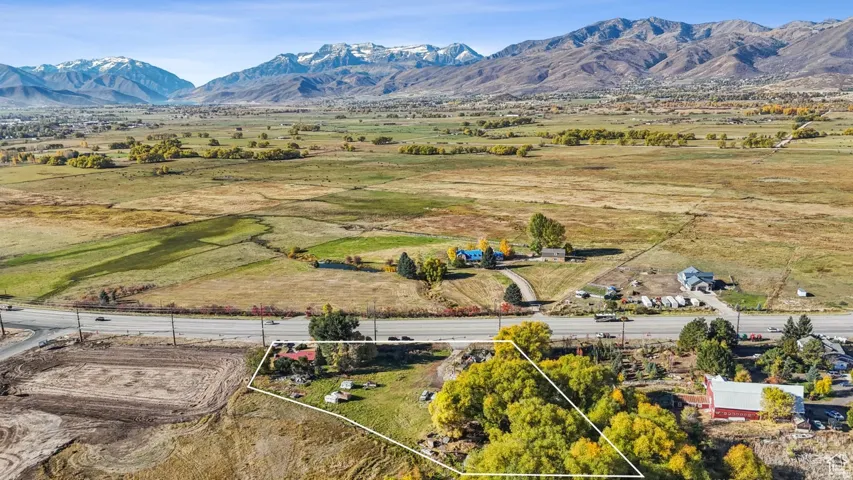 Expansive property outlined in white, featuring significant acreage and proximity to a paved road
