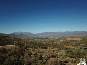 Expansive mountain landscape with distant snow-capped peaks