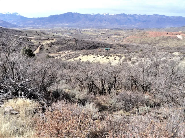 Expansive mountainous landscape with distant snow-capped peaks