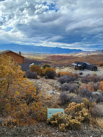 Elevated property featuring a natural, arid landscape with scattered deciduous and evergreen shrubs