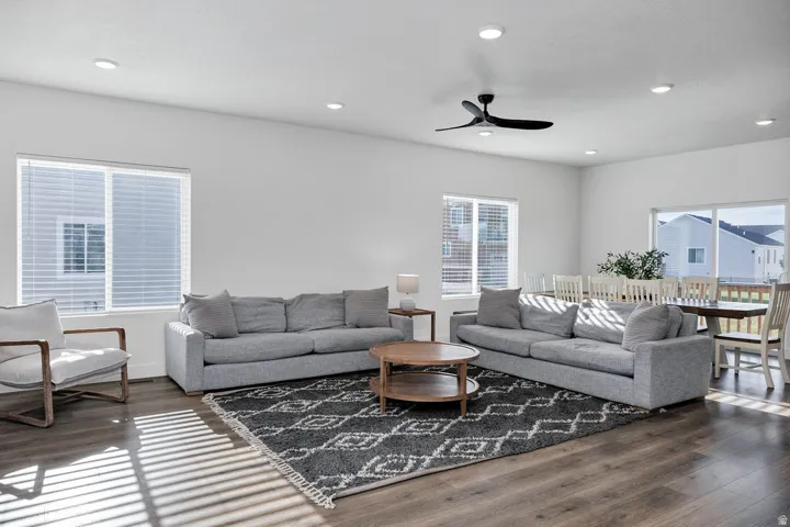 Open-concept interior featuring wood-finish flooring, recessed lighting, and a contemporary ceiling fan