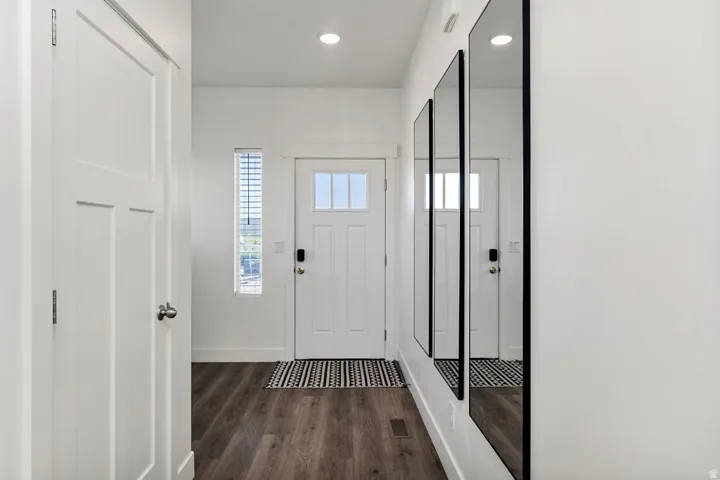 Entryway featuring wood-finish flooring and a white paneled door