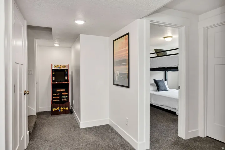 Hallway with recessed lighting, white walls, and gray carpet flooring