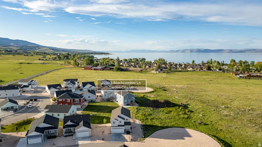 Aerial perspective showcasing a residential development with water and mountain scenery