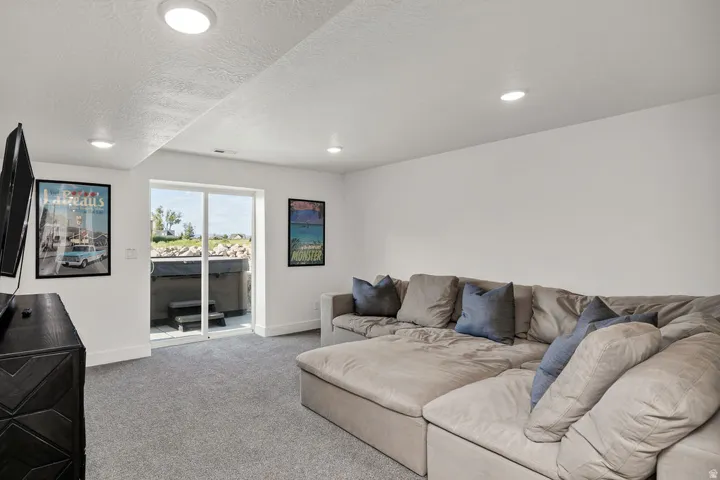 Recessed lighting illuminates this bright space with gray carpeting