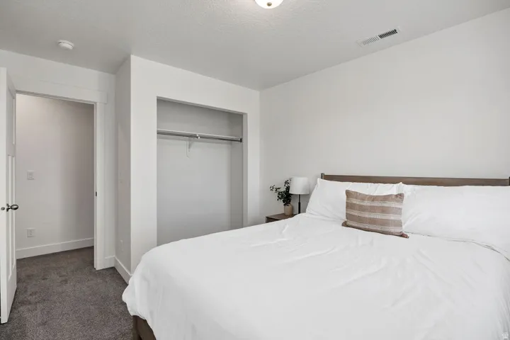 Neutral wall tones paired with dark gray carpeting