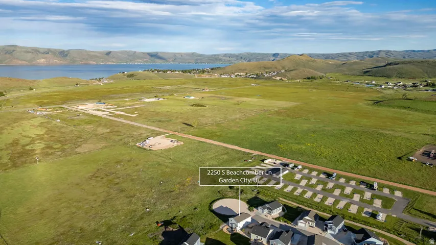 Expansive undeveloped land with distant lake and mountain scenery