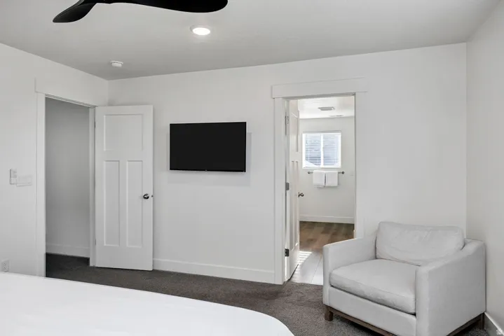 Bedroom featuring a ceiling fan, recessed lighting, wall-mounted television, and a three-panel interior door