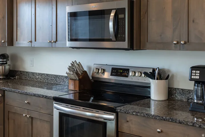 Stainless steel oven with electric cooktop, complemented by an over-the-range microwave