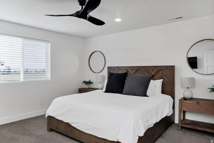 Bedroom featuring a wood-finish bed frame with a herringbone pattern headboard