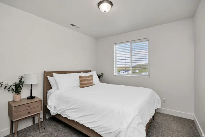 Bedroom featuring white walls, a single window with blinds, recessed lighting, and carpet flooring