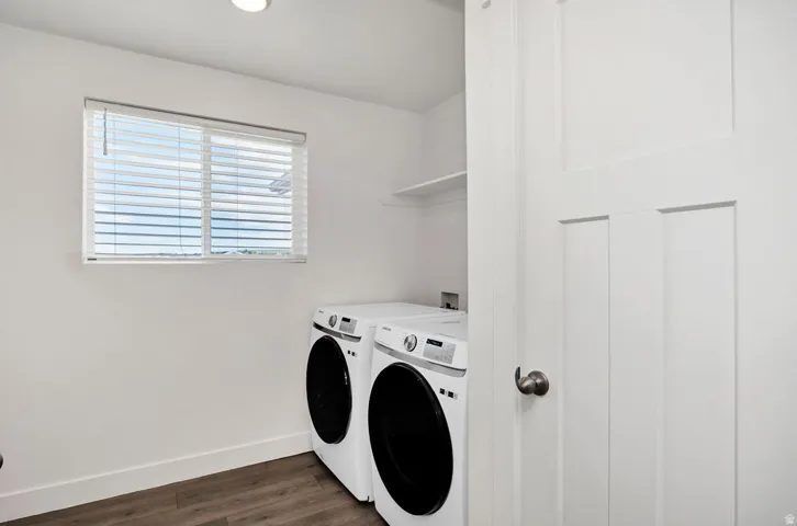 Dedicated laundry space featuring white walls and a window with blinds