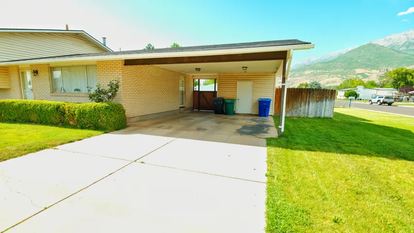 Property exterior featuring a single-story design, a covered carport, and a concrete driveway