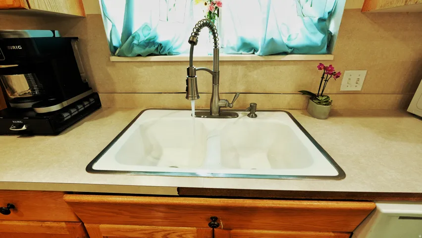 White double basin sink with a gooseneck faucet
