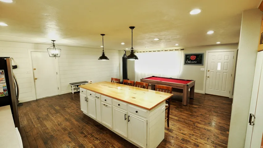 Open-concept space featuring wood-finish flooring and recessed lighting