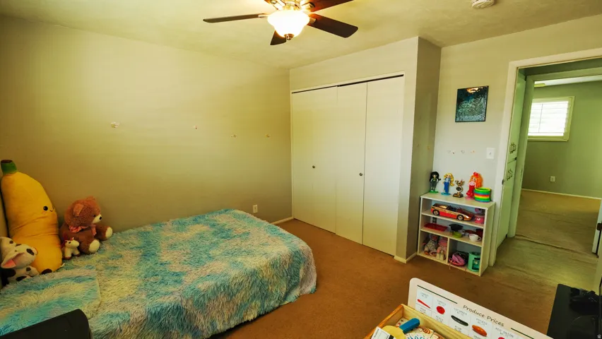 Bedroom featuring neutral wall paint and brown carpeting