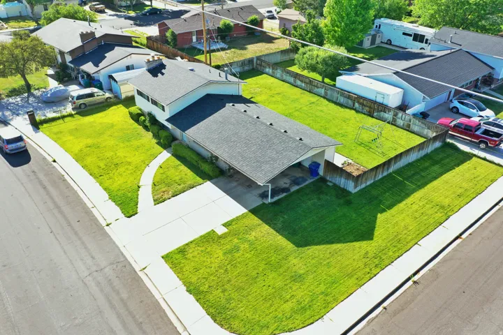 Single-family residence featuring a dark shingle roof and a spacious, fenced backyard