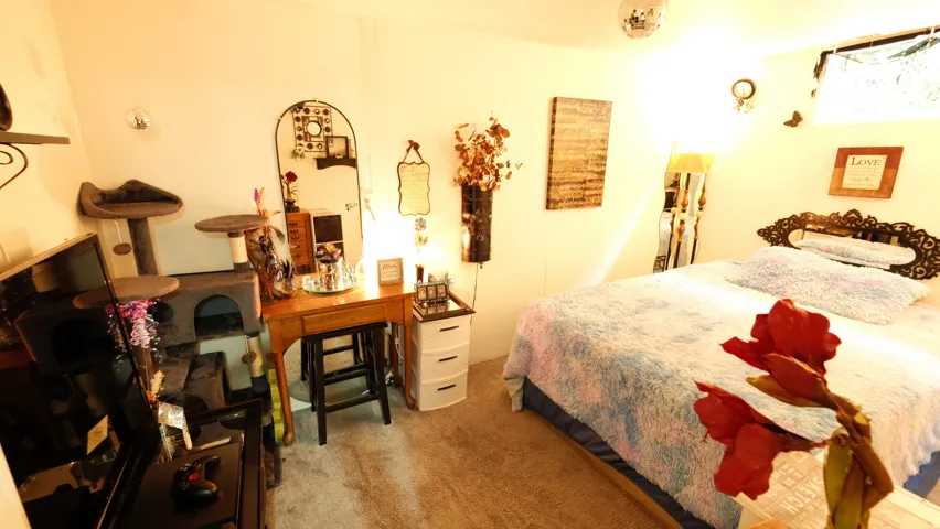 Carpeted room featuring a bed with an ornate headboard, a built-in wall shelf, a window, and recessed lighting