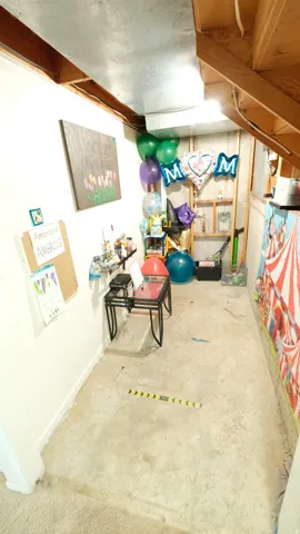 Unfinished basement area featuring exposed ceiling joists and concrete flooring