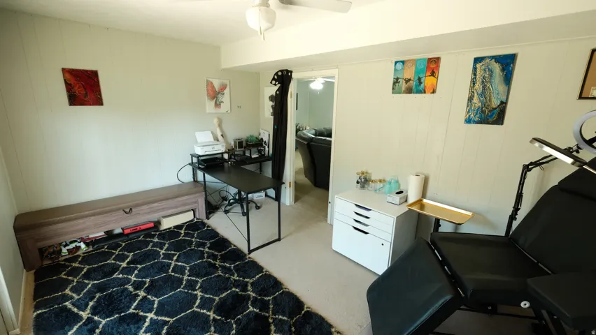 Versatile room featuring paneling details, recessed lighting, and a neutral carpeted floor