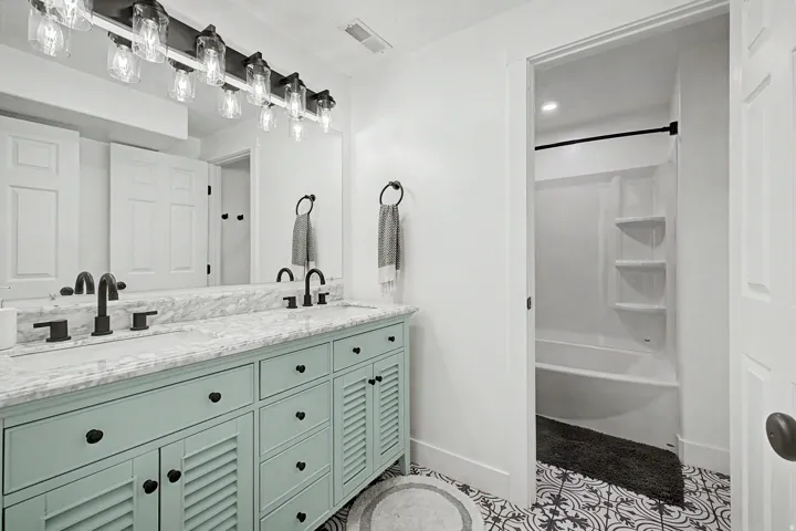 Dual vanity with a stone countertop and matte black fixtures