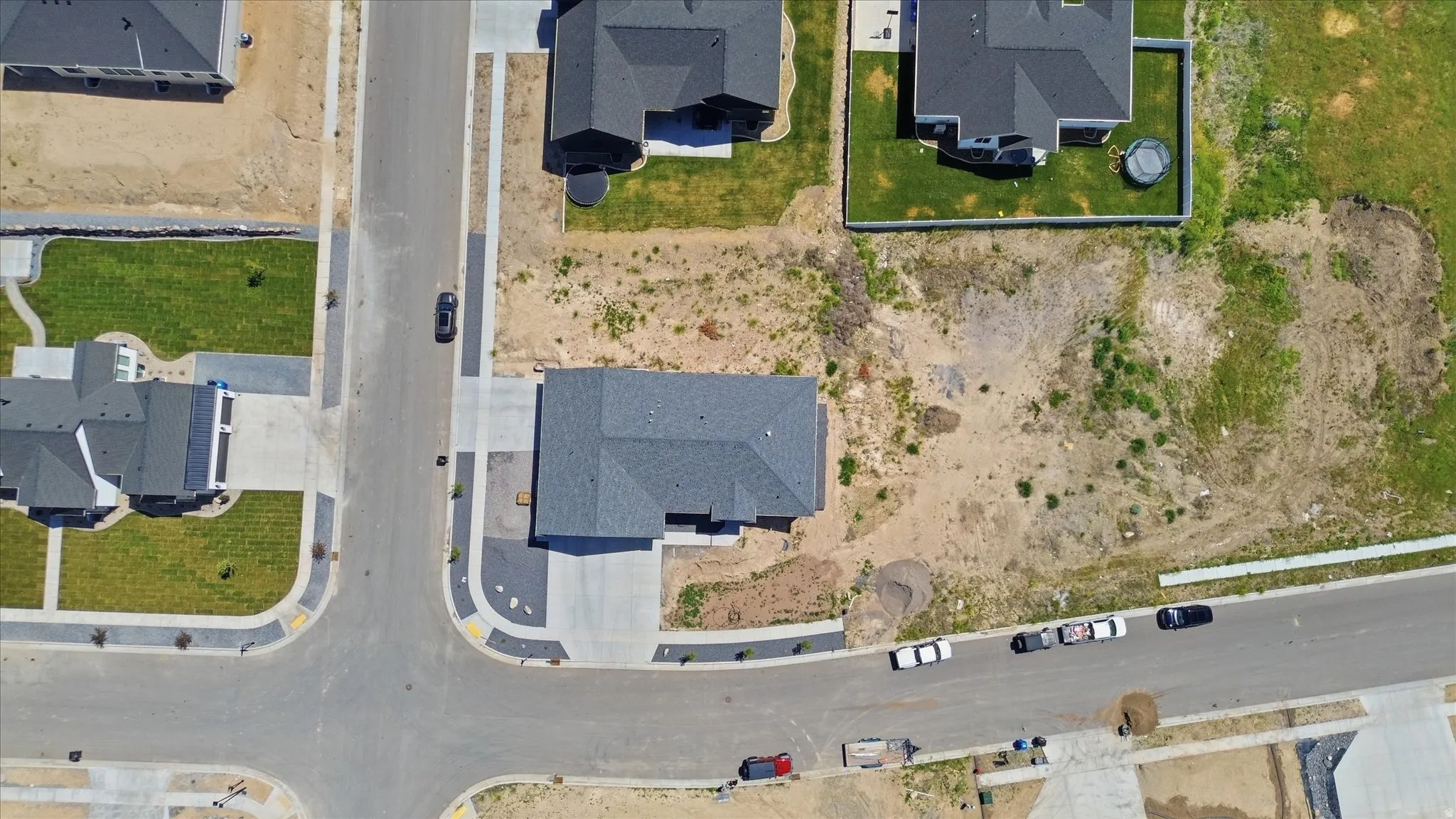 New construction home featuring a dark gray shingle roof and a concrete driveway